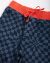 Checkered pants with orange waistband on a white background