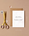 Greeting card with envelope and scissors on a beige background