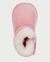 Pink children's slippers with white fur lining on a light gray background