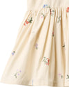 Beige dress with floral embroidery on a white background