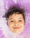 Child surrounded by purple and white bubbles