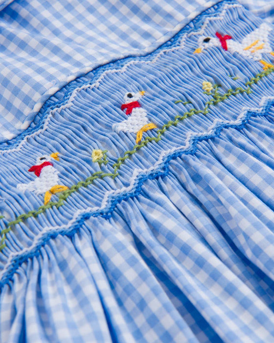 Blue checkered fabric with embroidered birds and flowers