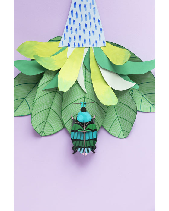 Gnome figure with a colorful hat and striped outfit on green leaf-like structures against a light purple background