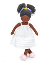 Toy doll with braided hair and a white dress on a white background