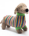 Knitted dog toy with a colorful striped sweater on a white background