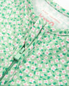 Close-up of a green fabric with pink floral pattern