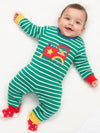 Baby wearing a green and white striped onesie with a train design on a white background