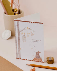  Greeting card with animal illustrations on a desk with stationery items