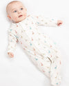 Baby in a white swaddle with colorful animal prints on a white background