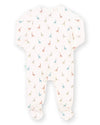 A baby footed sleeper in a warm off-white fabric, featuring a delicate all-over print of small colorful giraffes in blue, orange, and green.