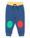Blue children's sweatpants with red and green circles on a white background