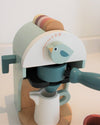 Children's toy coffee maker with a bird design on a light background