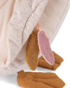 Brown baby socks with pinkies peeking out from under a pink blanket
