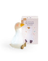 White goose figurine with packaging on a white background