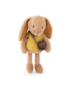 A plush bunny toy in light tan with long floppy ears, wearing a mustard yellow top and carrying a small brown crossbody bag, photographed on a clean white background.
