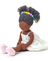 Stuffed doll with brown skin, gray hair with colorful beads, and a white dress on a white background
