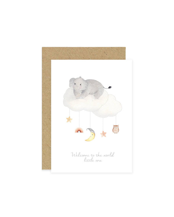 A baby greeting card with an illustration of an elephant, moon, rainbow, owl, and stars on a cloud mobile. The card has a beige background and a blank inside for a personal message.