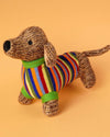 Dog toy with a striped sweater on an orange background