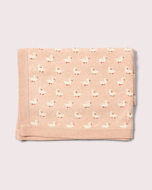  Folded pink blanket with duck pattern on a light gray background