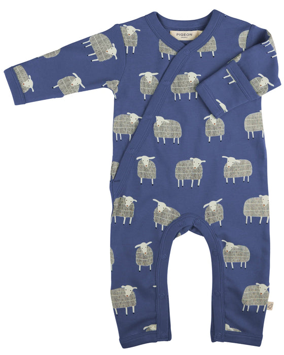 Blue baby onesie with sheep pattern on a white background