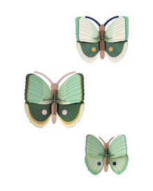  Three green butterflies with brown bodies on a white background