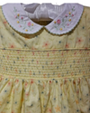 Vintage-style dress with floral pattern and embroidered collar on a plain background