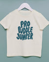Beige t-shirt with 'Pro Puddle Jumper' text on a hanger against a light blue background