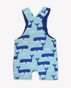 Children's blue romper with whale pattern on a white background