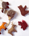 Set of felt animal ornaments including a fox, deer, hedgehog, bear, and squirrel on a white background.