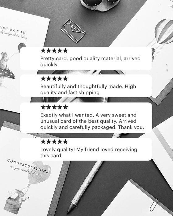 Greeting cards on a gray surface with customer reviews displayed.