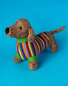 Knitted dog toy with a colorful striped sweater on a blue background