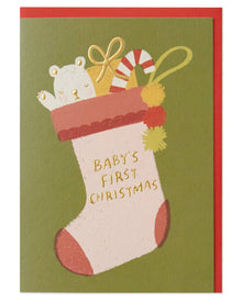  Christmas card with a stocking and baby's first Christmas text on a green background