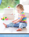 Child playing with toys on a light-colored floor.