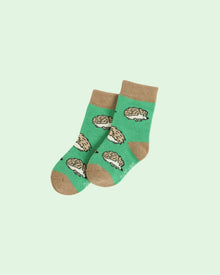  Green socks with hedgehog pattern on a light green background
