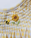 Close-up of a woven basket with embroidered flowers on a white background
