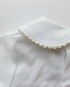 White fabric with lace trim on a light gray background