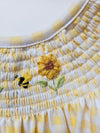 Close-up of a woven basket with embroidered flowers on a white background
