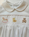 Close-up of a white garment with embroidered designs on a light background