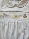 Close-up of a white garment with embroidered stars and a duck design.