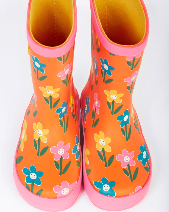 Orange rain boots with floral pattern on a white background